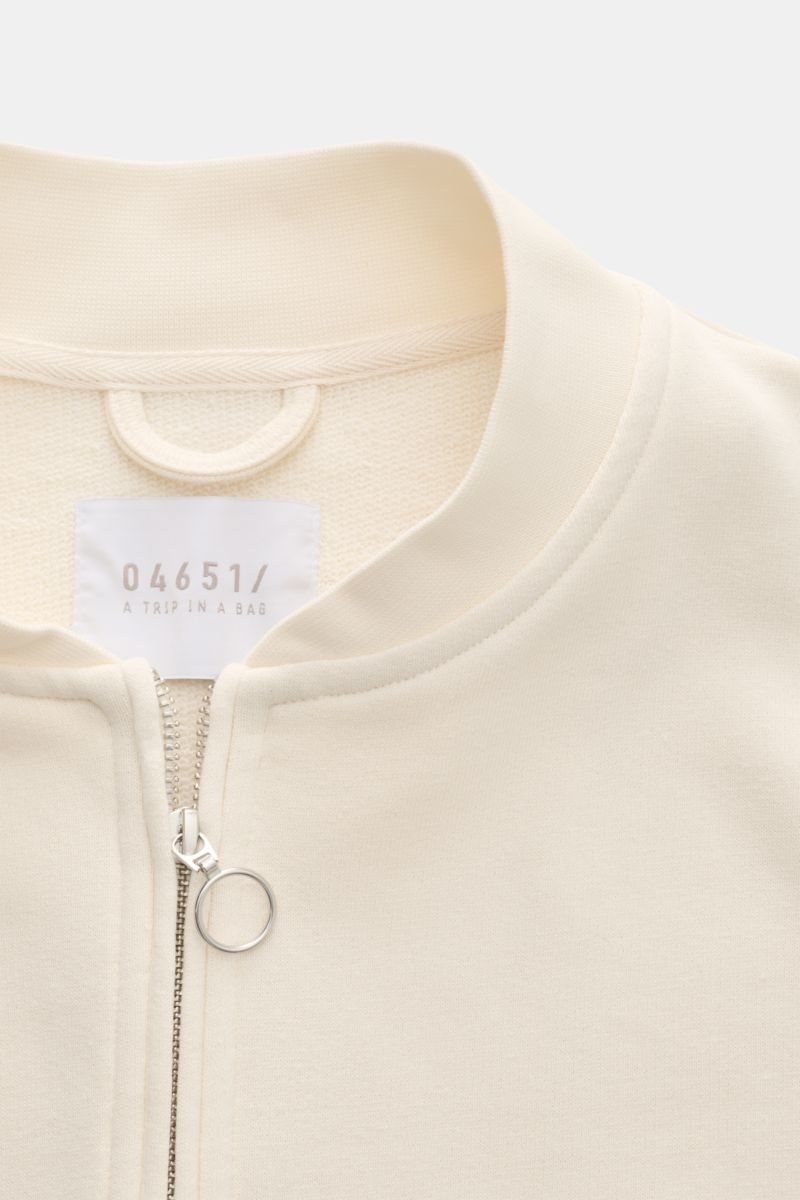 04651/ A trip in a bag Sweatjacke 'CL Bomber' creme, close-up von oben, Bio-Baumwolle-Leinen Mix, garment-dyed, robuster Zwei-Wege-Reißverschluss, Blousonkragen, Leistentaschen, Rippbündchen.