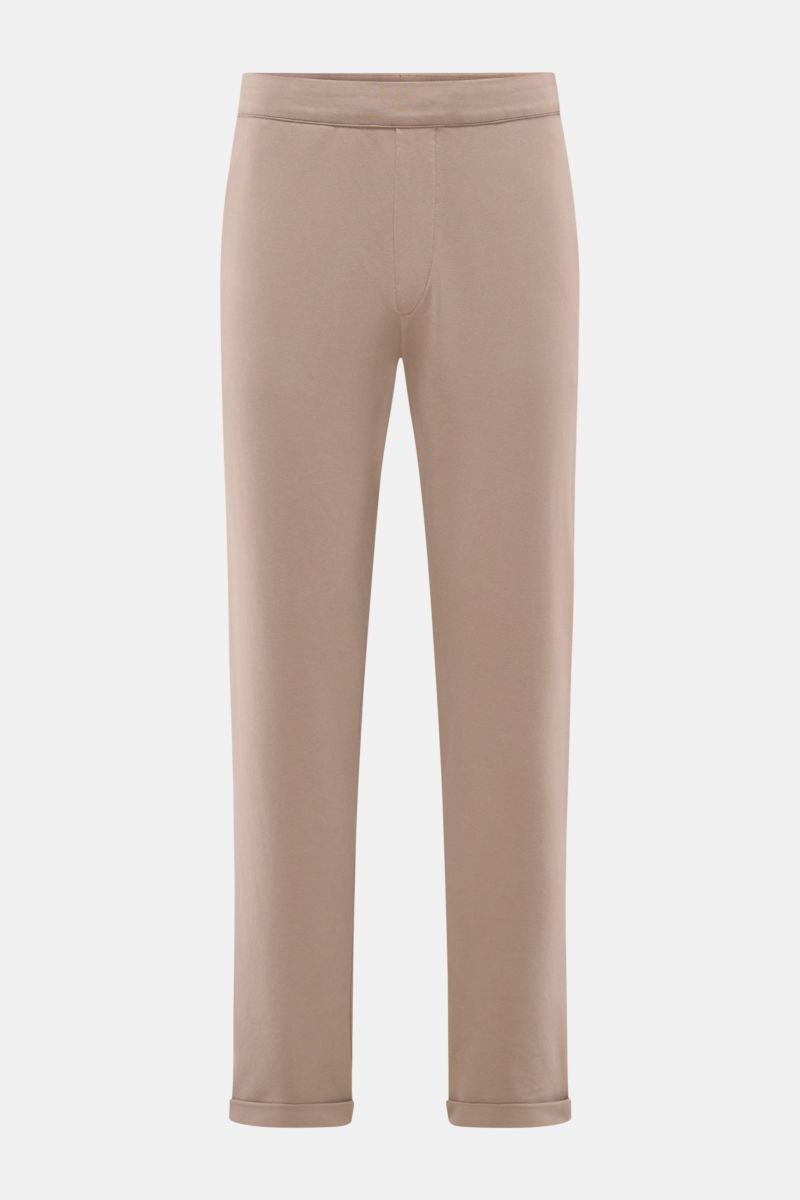 Front view of 04651/ A trip in a bag Jogger pants 'If' taupe in soft cotton jersey with tapered fit, elasticated waistband, drawstring, and fixed hem turn-up.

Description:
Comfort meets style: These jogger pants in soft cotton jersey by 04651/ A TRIP 