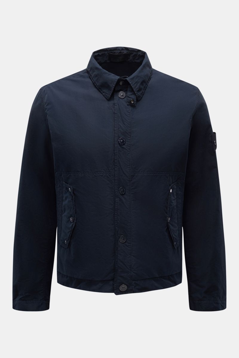 Front view of Stone Island Jacke 'Ghost Piece' navy, an urban essential jacket with slim fit, garment dyed microfiber, snap button placket, turn-down collar with button tab, flap front pockets, tonal compass badge on upper arm, and snap button cuffs.
