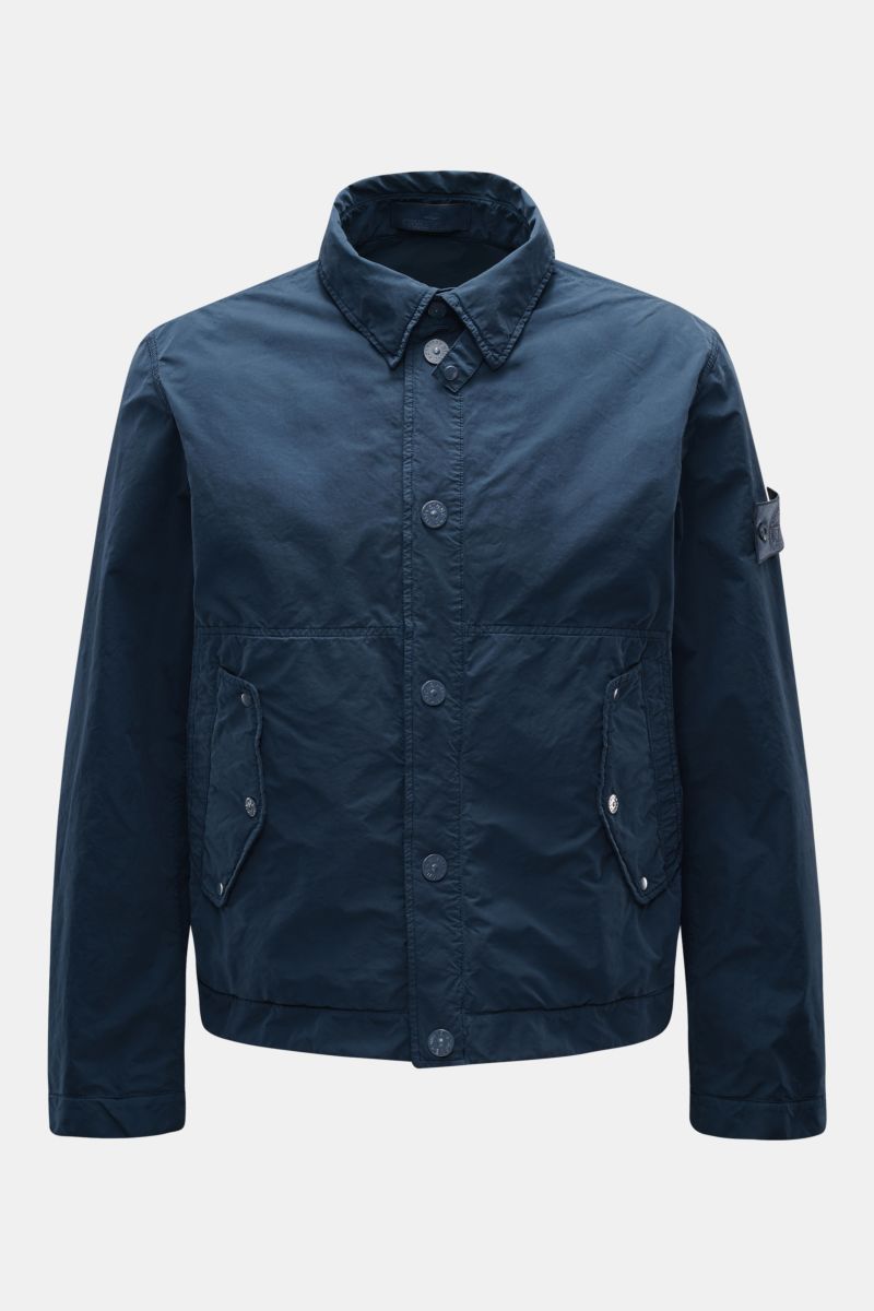 Stone Island Jacke 'Ghost Piece' dunkelblau, front view of slim fit jacket with soft microfiber, garment dyed look, button placket, collar, flap pockets, tonal badge, and snap cuffs. Urbanes Essential: Die STONE ISLAND Jacke aus der 'Ghost Collection' übe