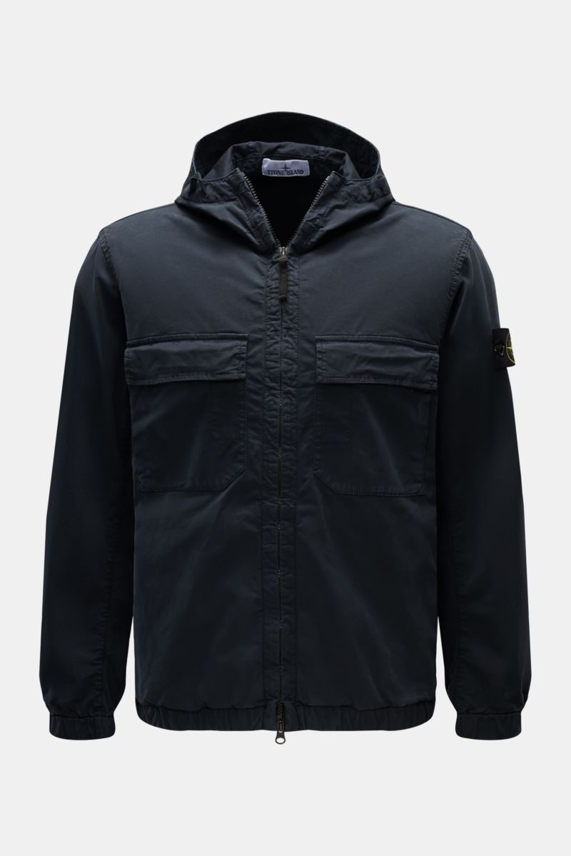 Front view of Stone Island Blouson 'Stretch Cotton Twill-TC' navy, a slim fit spring jacket with elastic cotton, soft touch, garment dyed fabric, two-way zipper, hood with drawstring, chest and side seam pockets, and elastic hem and cuffs.