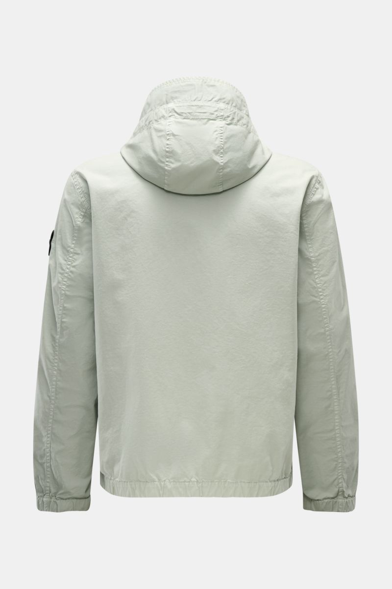 Back view of Stone Island Blouson 'Stretch Cotton Twill-TC' sage, a slim fit, lightweight cotton jacket with elasticated cuffs and hem, garment-dyed finish, drawstring hood, patch breast pockets, side seam front pockets, and a robust two-way zip, perfect 