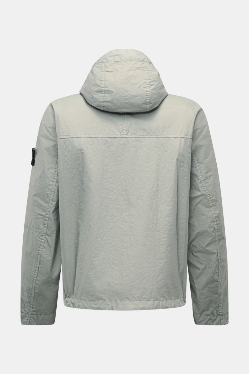 Rear view of Stone Island Jacket 'Membrana' sage in lightweight, wind and water repellent microfiber with adjustable hem and compass badge.