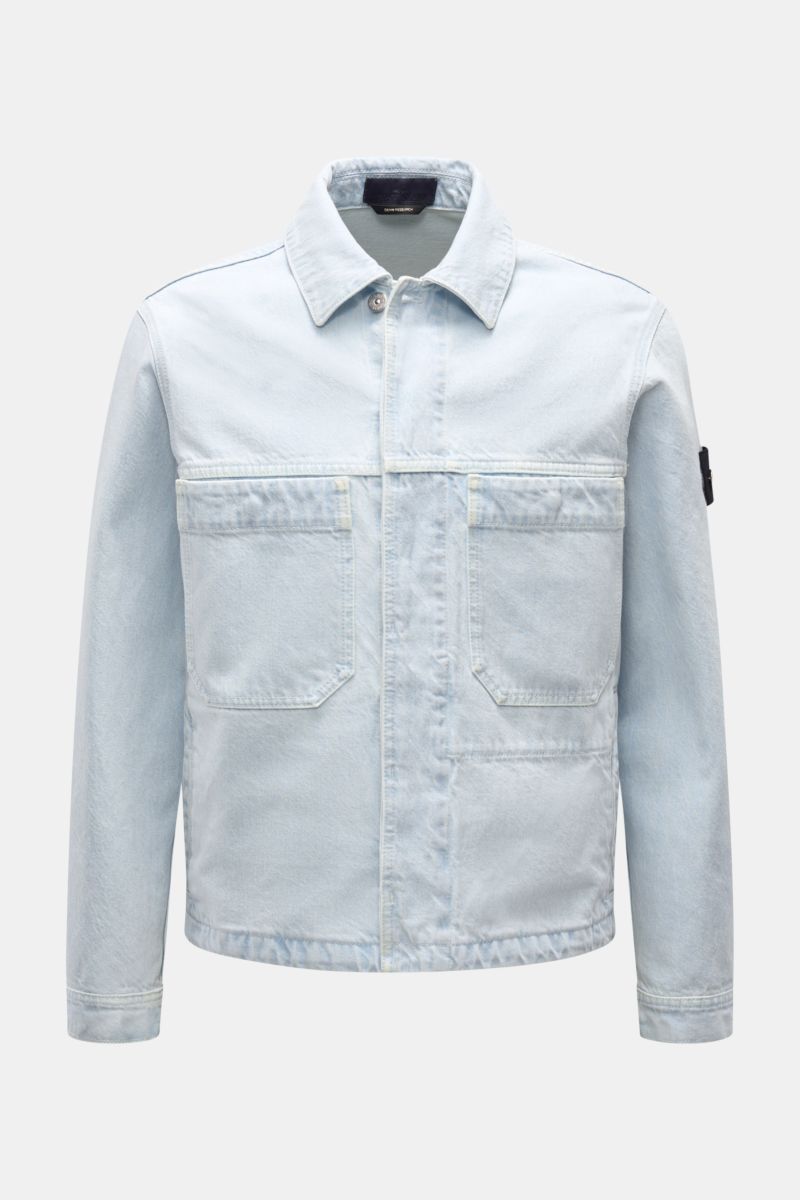 Front view of Stone Island Denim jacket pastel blue in slim fit, featuring pure cotton denim, patch front pockets, concealed button placket, turn-down collar, four front pockets, cuffs with button, and compass badge on upper sleeve. A timeless companion f