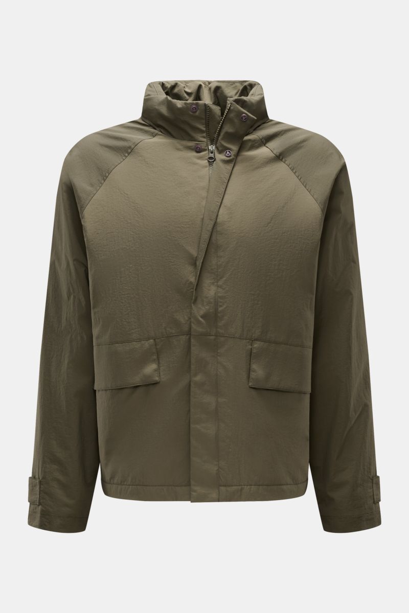 Front view of the 04651/ A trip in a bag Jacket olive made of high-quality microfibre with smooth feel, lightweight padding, wind and water repellent, regular fit, zip, concealed hood in collar, raglan sleeves, hip pockets with flap, small woven label in 