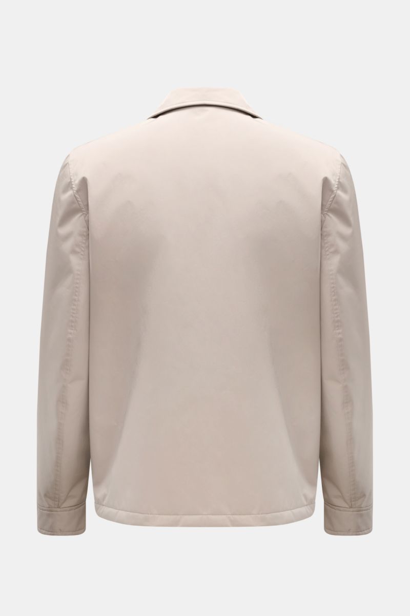 Back view of the Brunello Cucinelli Jacke sand, a regular fit jacket in high-quality sand-colored microfiber with a smooth, soft texture. The jacket features a classic collar, long sleeves with buttoned cuffs, and a lightweight, wind- and water-repellent 