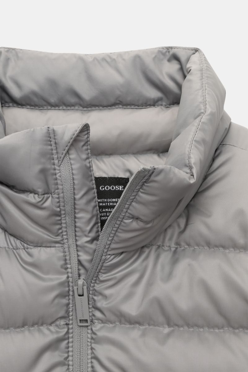 Canada Goose Down jacket 'Stratus Tonal' light grey shown from a close-up front perspective highlighting the padded standing collar and zip. The super lightweight 'Stratus Tonal' down jacket by CANADA GOOSE with high-quality ripstop outer material is s