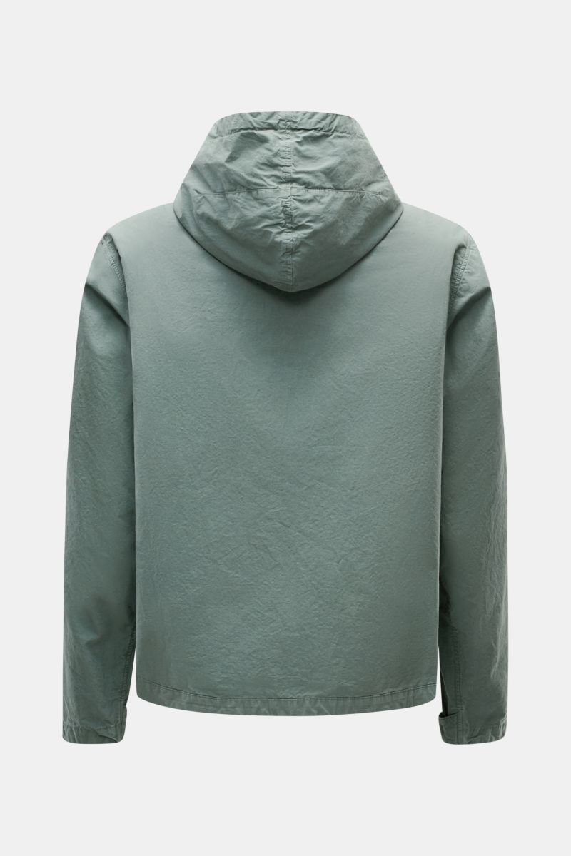 Back view of the C.P. Company Jacket sage in light green, showing the hood and long sleeves, made from lightweight, garment-dyed pure cotton Micro-Reps fabric with a soft feel.