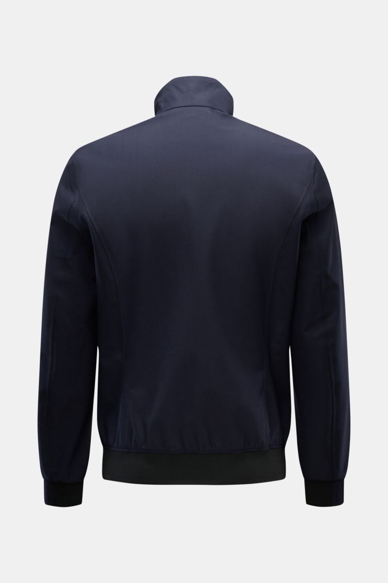 Rear view of UBR Blouson 'Bullet Savile' navy, showcasing minimalist, slim fit design with standing collar and flexible knit bands. Minimalist and functional: With its ultra lightweight design and the fine wool fabric, this 'Bullet Savile' blouson from UB