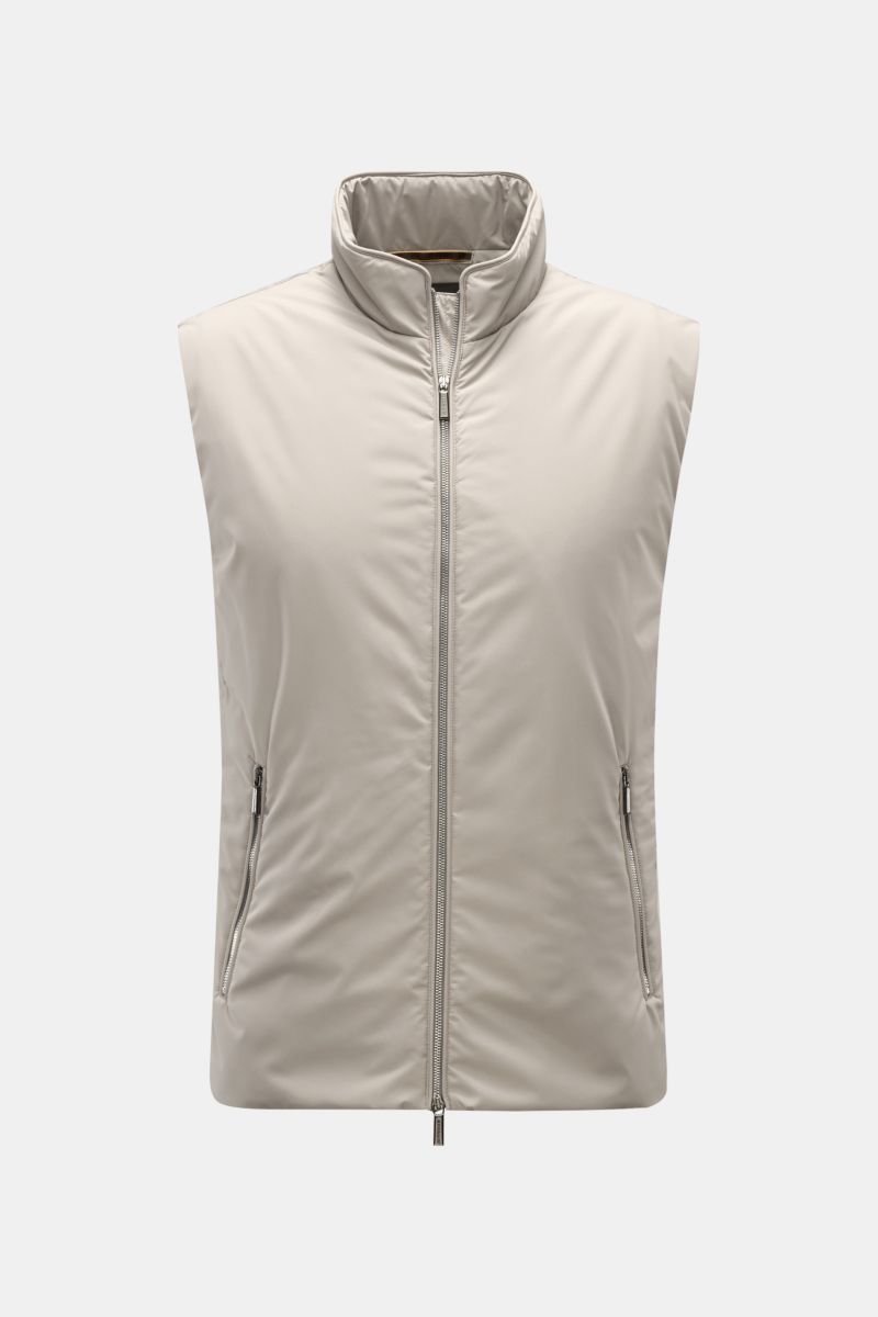 Front view of the Moorer Outdoor-Weste 'Senio-Skt' beige, a lightweight, slim fit outdoor vest with water-repellent microfiber, smooth texture, light filling, two-way zipper, narrow stand-up collar, slanted zipper front pockets, and one inner pocket, desi