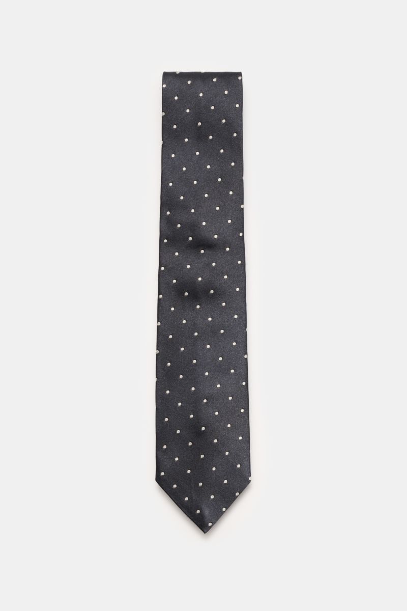 Top-down view of the Tom Ford Seidenkrawatte anthrazit/creme gepunktet, a silk tie with subtle sheen and cream polka dots.

Description: Zeitloser Stil mit luxuriöser Note: Die Seidenkrawatte von TOM FORD überzeugt als elegantes Essential für formelle 