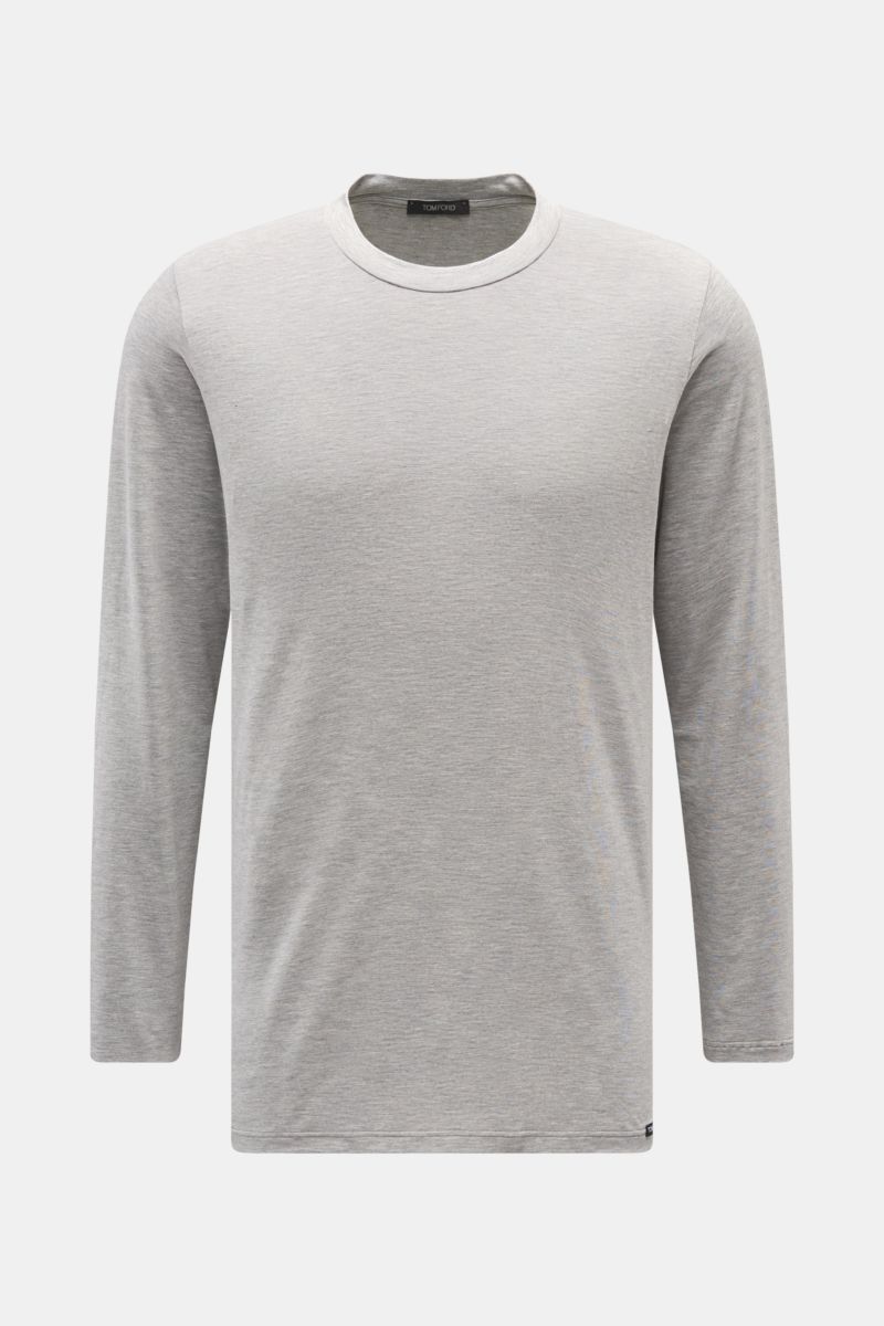 Front view of Tom Ford Langarm-Unterhemd schwarz, a clean basic long-sleeve shirt with round neckline, made from a soft cotton-modal blend, regular fit, featuring a small TOM FORD label at the hem. 

Description: Cleanes Basic mit Rundhalsausschnitt: D