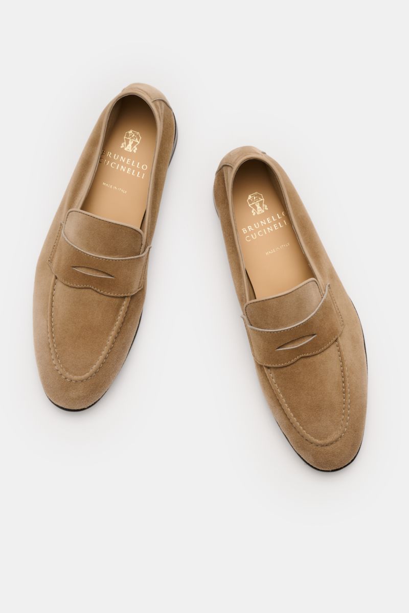 Brunello Cucinelli Penny Loafer beige shown from a top-down view, featuring smooth velour leather, Goodyear-welted, narrow shape, typical penny strap, leather lining, and flexible leather sole for stylish comfort and flexibility.