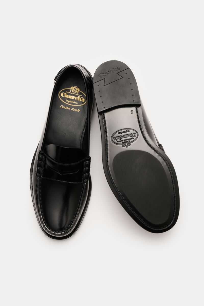 Church's Penny Loafer 'Rowley' schwarz shown from top and bottom views, featuring polished smooth leather, Goodyear welted, slim silhouette, penny strap, decorative stitching, leather lining, leather sole, and rubber-reinforced heel.