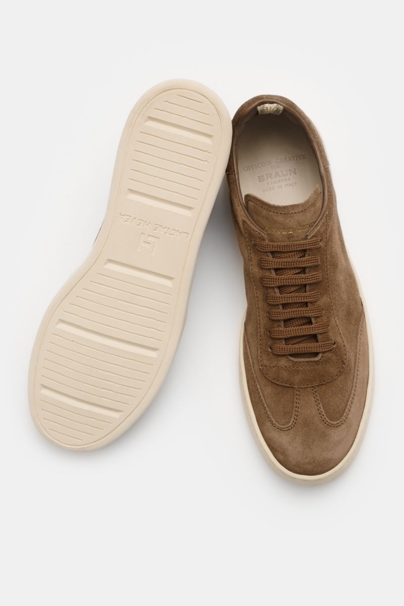 Top-down view of Officine Creative Sneakers 'Kafka' taupe in premium suede with round toe cap, wing cap, embossed logo on tongue and heel, high padded topline, leather lining, and lightweight rubber sole.

Description: For anyone who appreciates comfor