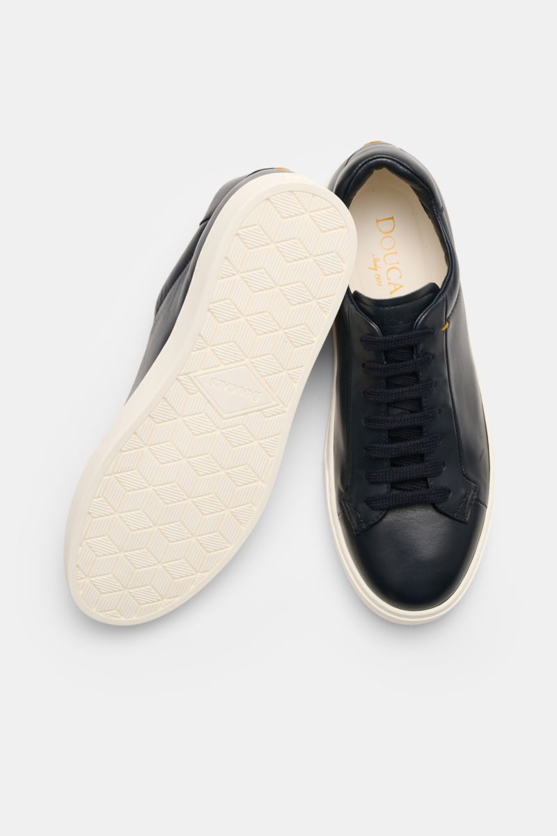 Doucal's Sneakers 'Plonge' dark navy shown from above with one shoe sole up, low top smooth leather, seven-eyelet lacing, padded topline, leather lining, flexible rubber sole.