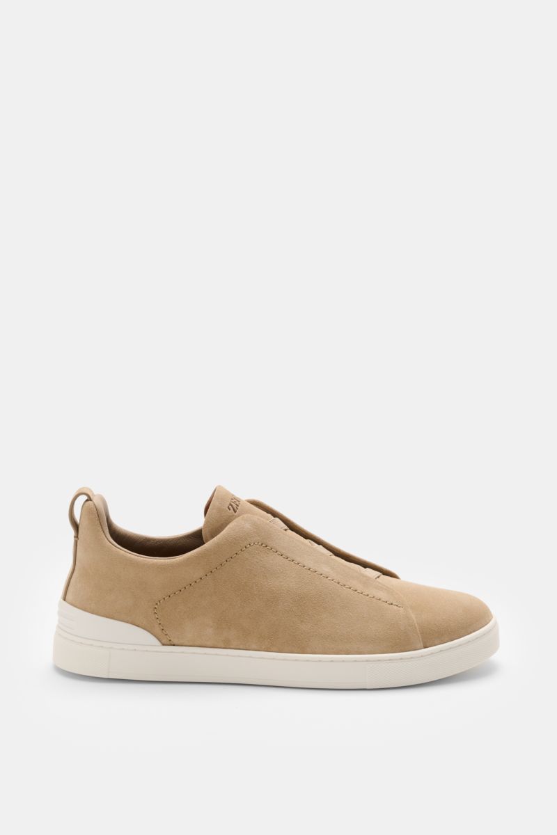 Side view of Zegna Slip-on sneakers 'Triple Stitch' sand in smooth suede with round toe, crossed elastic straps, padded topline, pull loop, ZEGNA embossed tongue, leather lining, and flexible rubber sole.
