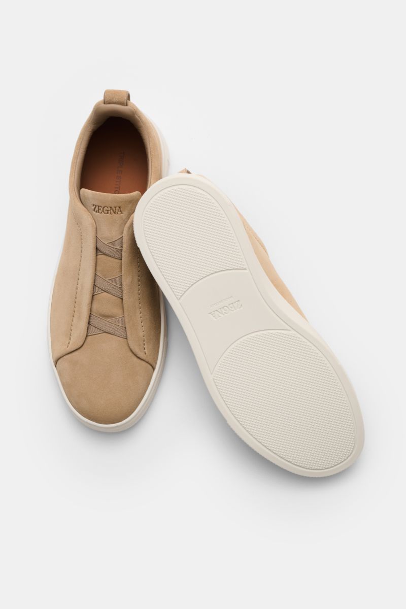 Zegna Slip-on sneakers 'Triple Stitch' sand shown from above and side, lightweight slip-on in smooth suede with crossed elastic straps, round toe cap, high padded topline, pull-on loop, ZEGNA embossed tongue, leather lining, and flexible rubber sole.