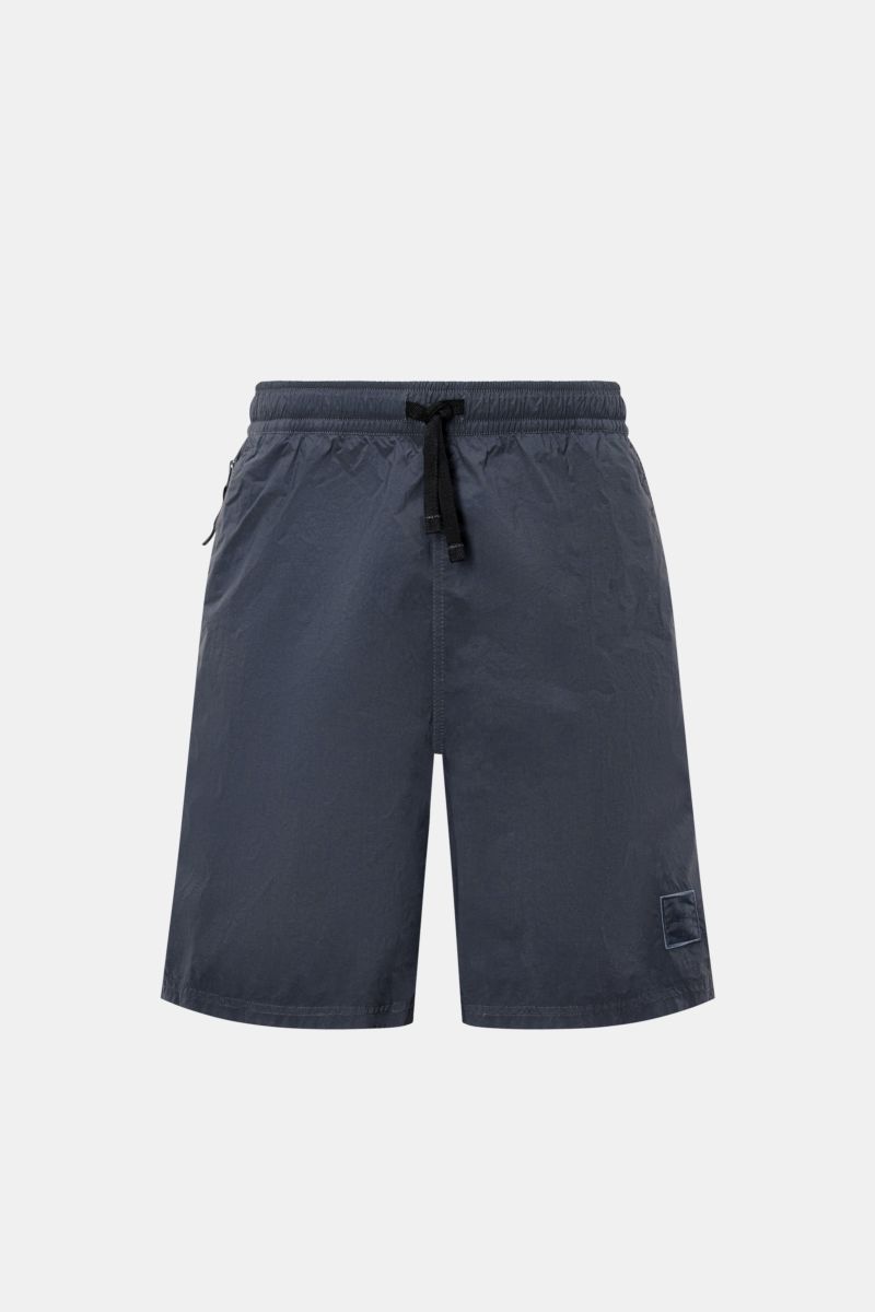 Front view of Stone Island Swim shorts 'Ghost Piece' grey-blue in high-quality microfibre with elasticated waistband, drawstring, and zip pockets.

Description: A monochrome look in classic STONE ISLAND style: on the beach or at the pool, these swim sh