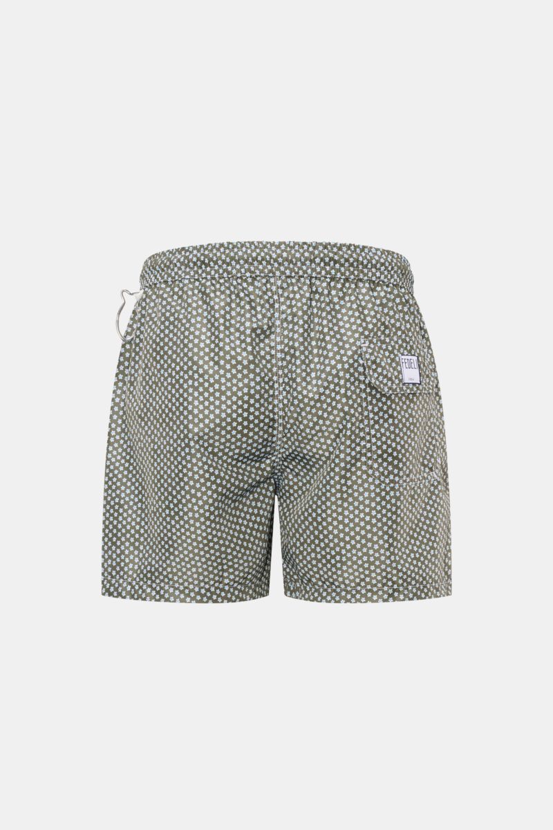 Rear view of Fedeli Swim shorts 'Madeira Airstop' green/white/light blue patterned with elasticated waistband, back pocket, and whale-shaped carabiner.

Description: An essential for your summer vacation: These FEDELI swim shorts have an expressive pat