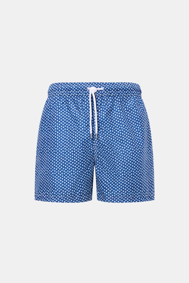 Front view of Fedeli Swim shorts 'Madeira Airstop' blue/white/light blue patterned with elasticated waistband, white drawstring, and floral design.

Description: An essential for your summer vacation: These FEDELI swim shorts have an expressive pattern th
