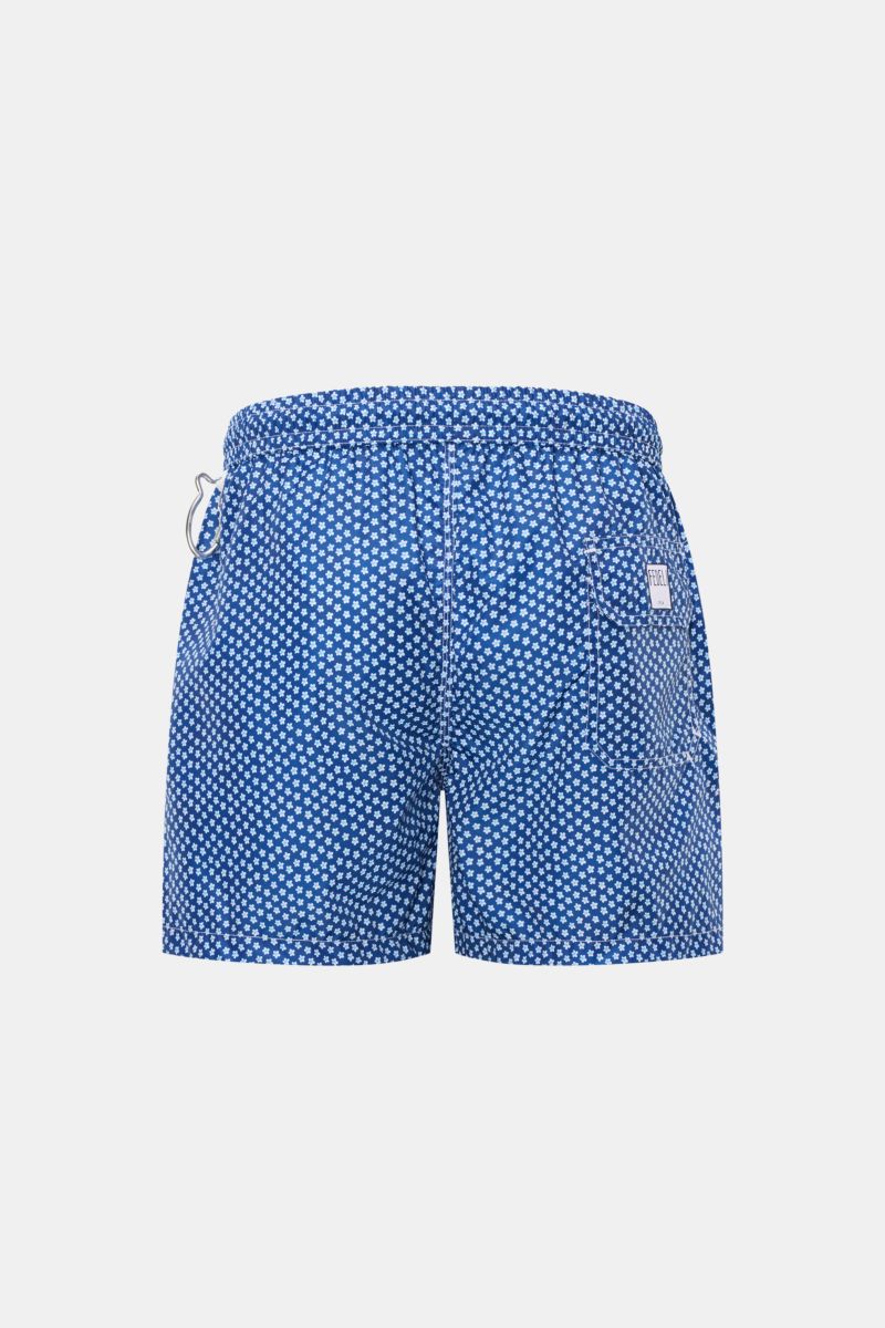 Rear view of Fedeli Swim shorts 'Madeira Airstop' blue/white/light blue patterned with elasticated waistband, back pocket, and whale-shaped carabiner.

An essential for your summer vacation: These FEDELI swim shorts have an expressive pattern that adds