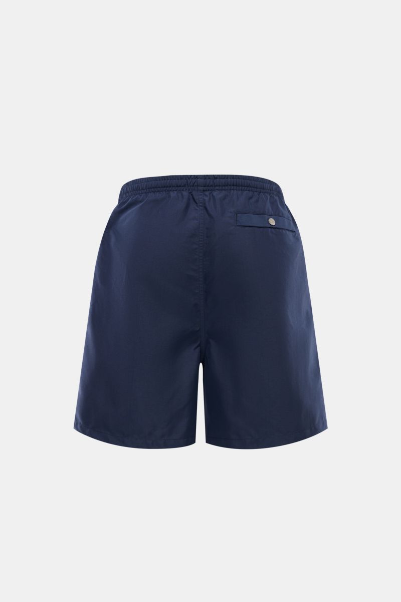 Rear view of Ami Paris Swim shorts navy in smooth navy microfibre with elastic waistband, back snap button pocket, and regular fit.

Description: Perfect for beach and pool: These swim shorts by AMI PARIS combine sporty style with fine microfibre fabri