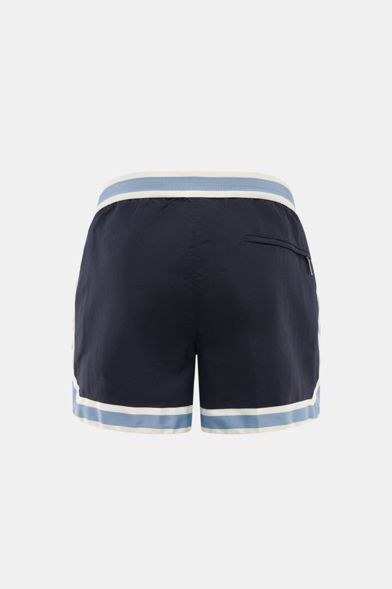 Ché Swim shorts 'Baller' navy shown from the back, featuring a retro short cut with elasticated waistband, zip and snap button, and zippered back pocket. 

The swim shorts 'Baller' by CHÉ give summery vibes and have a short cut in a retro design that m