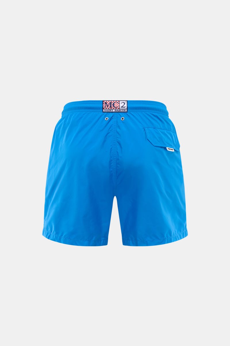 Back view of MC2 Saint Barth Swim shorts 'Lightning Pantone' blue, lightweight recycled microfibre with elastic waistband, side pockets, back flap pocket, mesh lining, and branded labels.

Description: Immerse yourself in the refreshing collaboration b