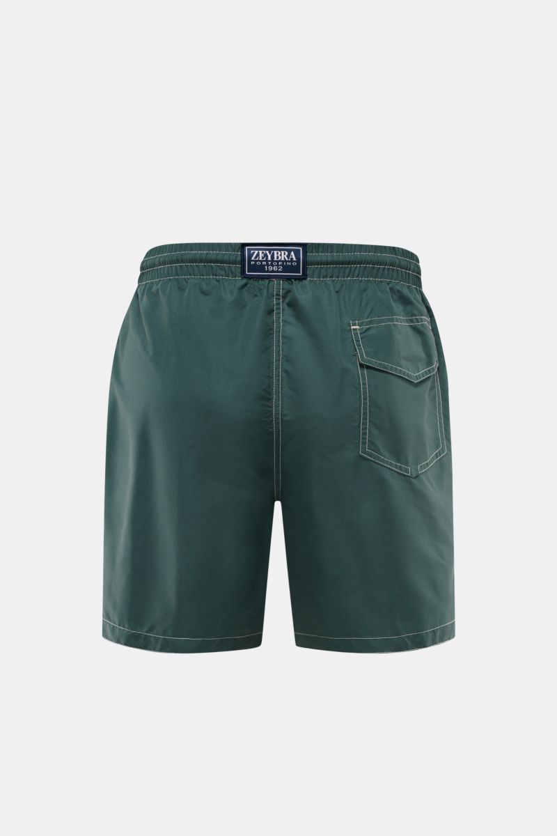 Rear view of Zeybra Portofino 1962 Badeshorts 'Lux Car' dunkelgrün/salbei in dark green and sage, showcasing elastic waistband with drawstring, back pocket with Velcro, and short side slits. Sommerliches Statement: Mit ihrem markanten Print werden die 