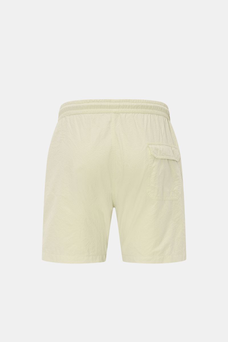Rear view of 04651/ A trip in a bag Swim shorts 'Mono Seersucker' sage in seersucker microfibre, elastic waistband, side and back pockets, and mesh lining. Perfect for your next summer holiday: With their design in seersucker look, these swim shorts by 04