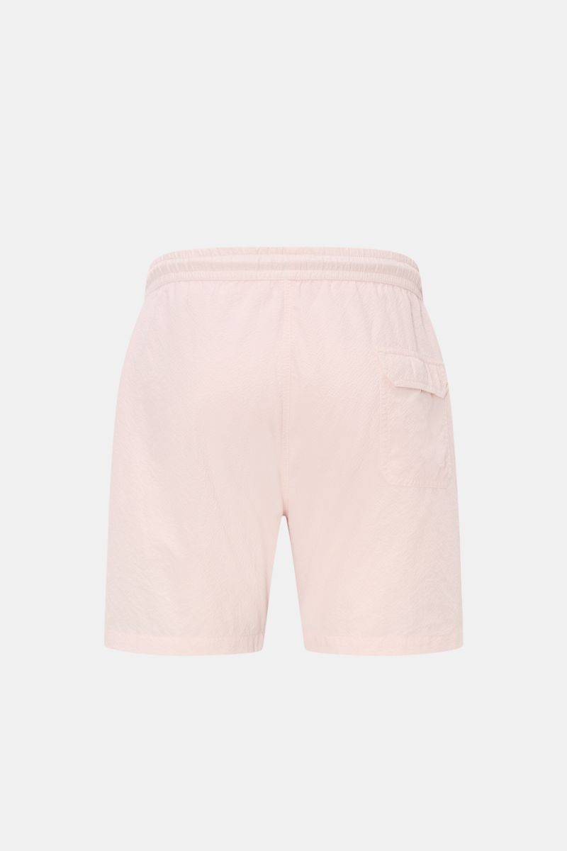 Rear view of 04651/ A trip in a bag Swim shorts 'Mono Seersucker' rose in light pink seersucker fabric with elastic waistband and back pocket.

Description: Perfect for your next summer holiday: With their design in seersucker look, these swim shorts b