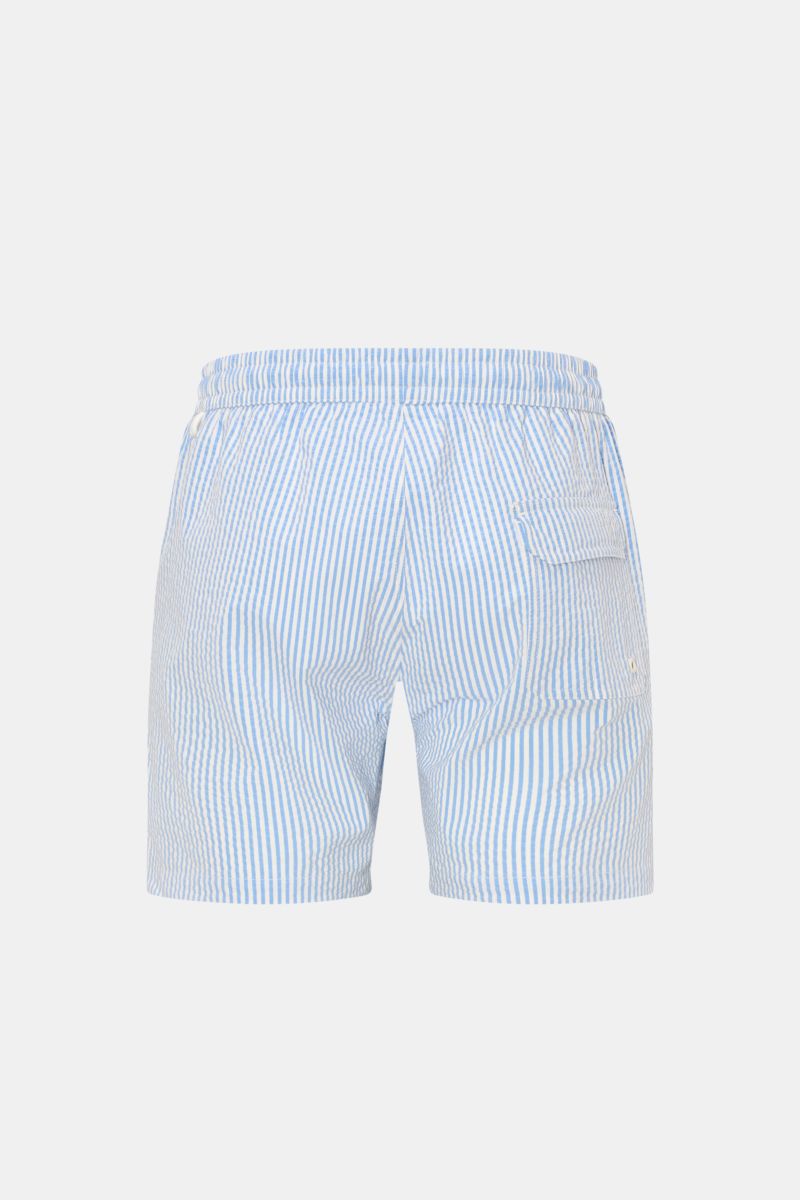 Rear view of 04651/ A trip in a bag Swim shorts blue/white striped with elastic waistband, side pockets, back pocket with flap, and side vents.

Perfect for your next summer holiday: With their modern striped pattern, these swim shorts by 04651/ A TRIP