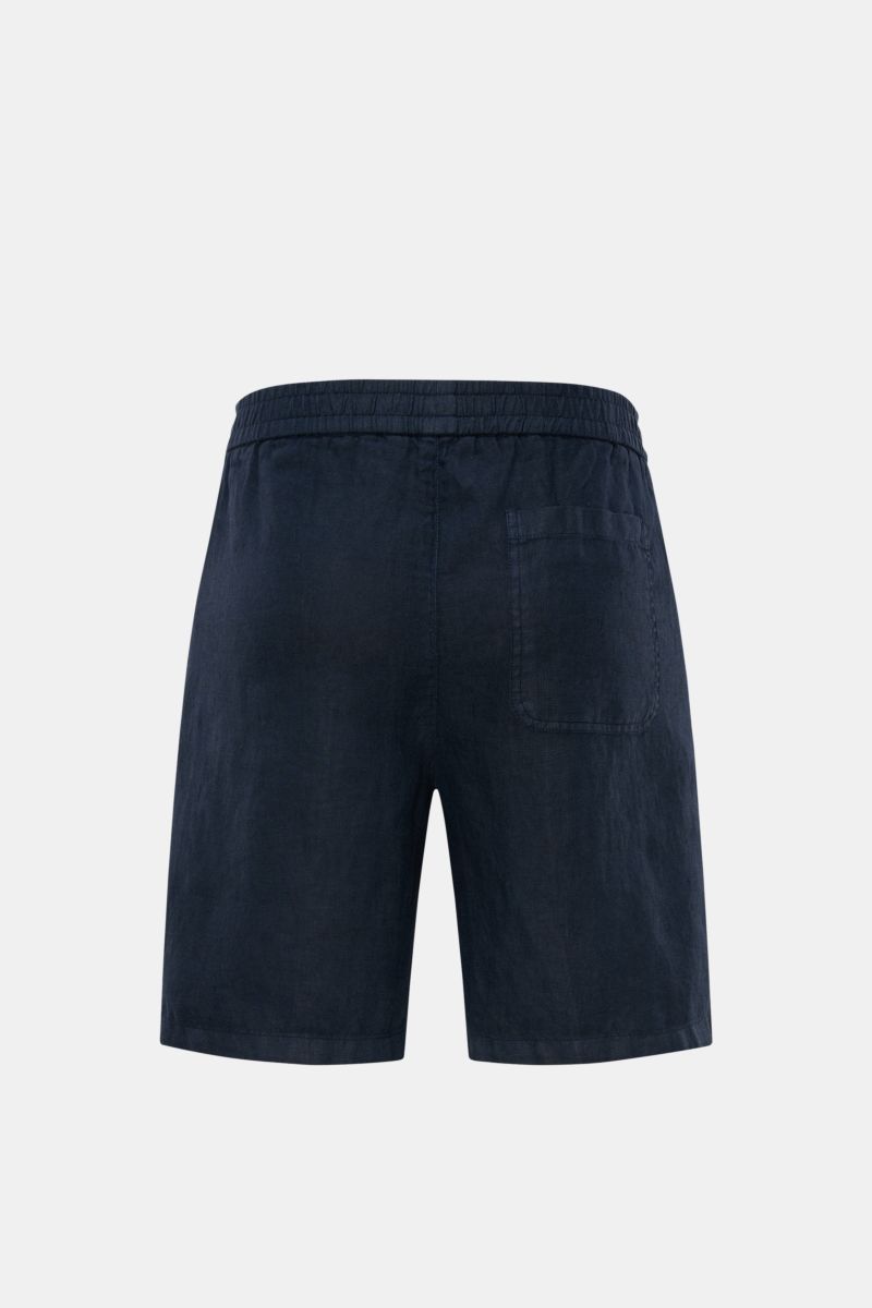 Rear view of 04651/ A trip in a bag Linen shorts navy in garment-dyed, soft, airy navy linen with elastic waistband, patch back pocket.

Description: With this airy model, 04651/ A TRIP IN A BAG presents a comfortable pair of pure linen shorts that are