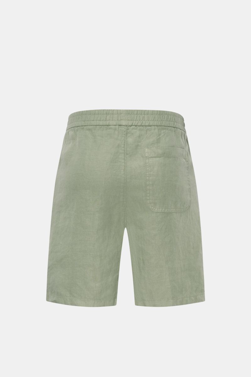 Rear view of 04651/ A trip in a bag Linen shorts sage in soft, garment-dyed airy linen with elastic waistband, French and patch pockets.

Description: With this airy model, 04651/ A TRIP IN A BAG presents a comfortable pair of pure linen shorts that ar