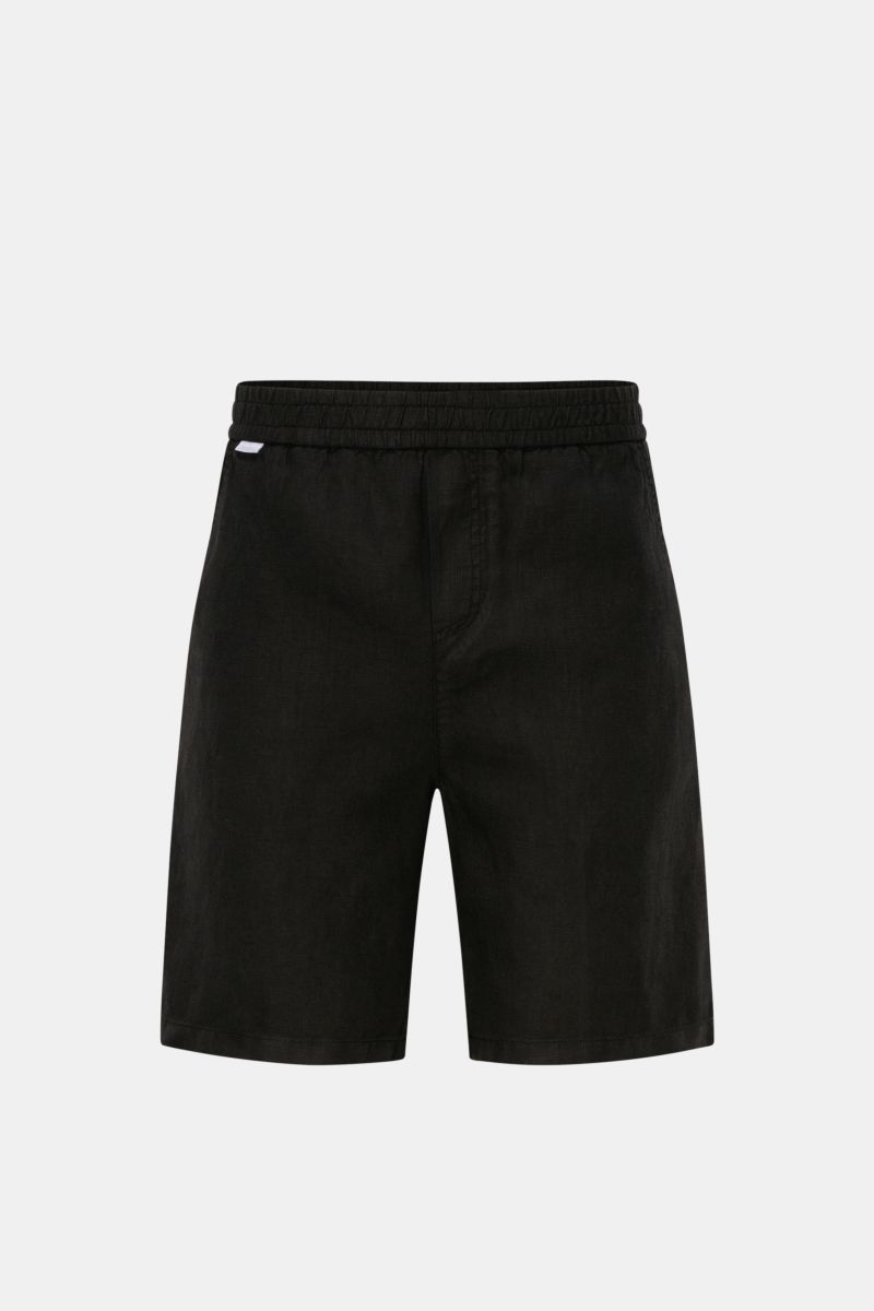 Front view of 04651/ A trip in a bag Linen shorts black, made of airy linen fabric with elastic waistband, French pockets, and patch back pocket.

Description: With this airy model, 04651/ A TRIP IN A BAG presents a comfortable pair of pure linen short