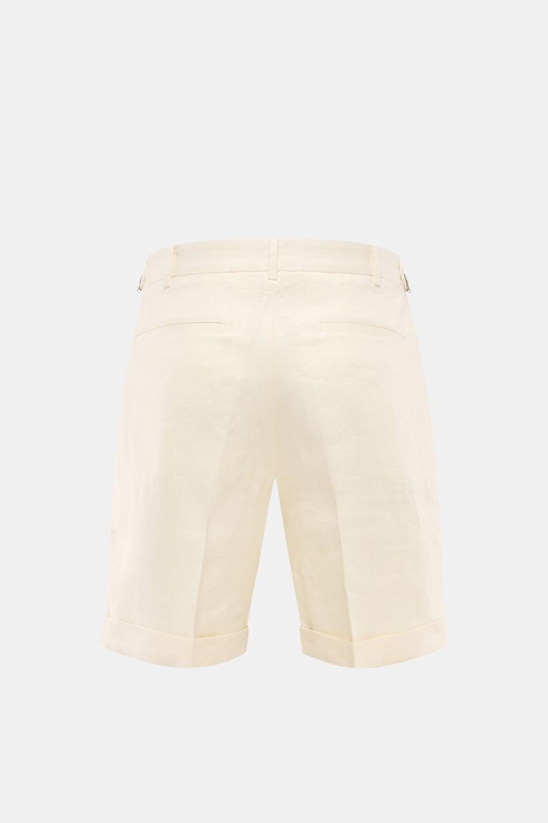 Rear view of 04651/ A trip in a bag Linen shorts cream in pure linen with double pleats, side adjusters, French and hip pockets, fixed hem turn-up.

Description: Perfect for warm days: These linen shorts by 04651/ A TRIP IN A BAG are the ideal summer e