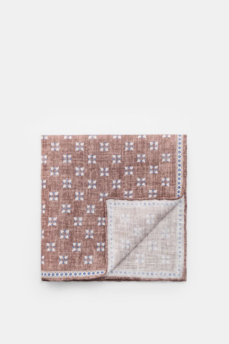 Rosi Collection Linen pocket square 'Fox' brown/blue/off-white patterned, folded with corner turned up, pure linen, soft feel, floral print with edging, rolled edges, made in Italy, 31 cm x 31 cm, top-down view.