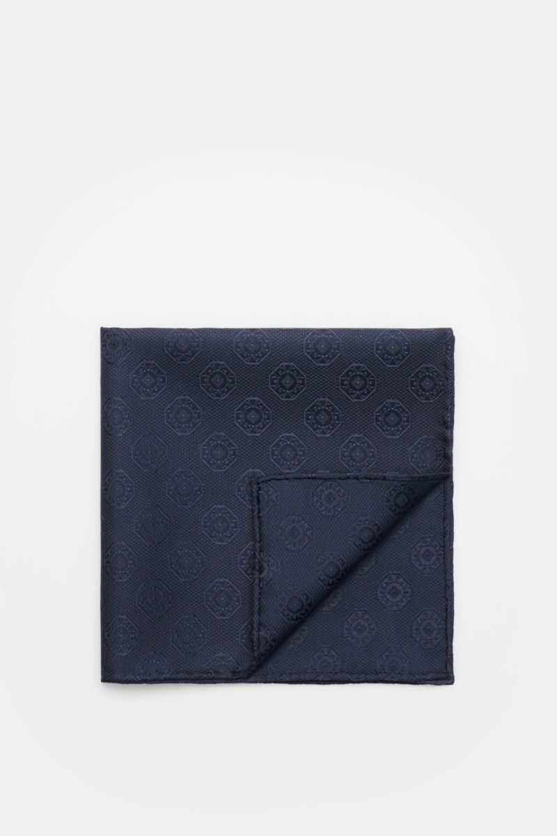 Top-down view of the Brunello Cucinelli Silk pocket square dark navy, patterned, folded to show its medallion weave and rolled edges.

Elegant accent: This silk pocket square by BRUNELLO CUCINELLI has a fine medallion weave pattern that creates a subtl