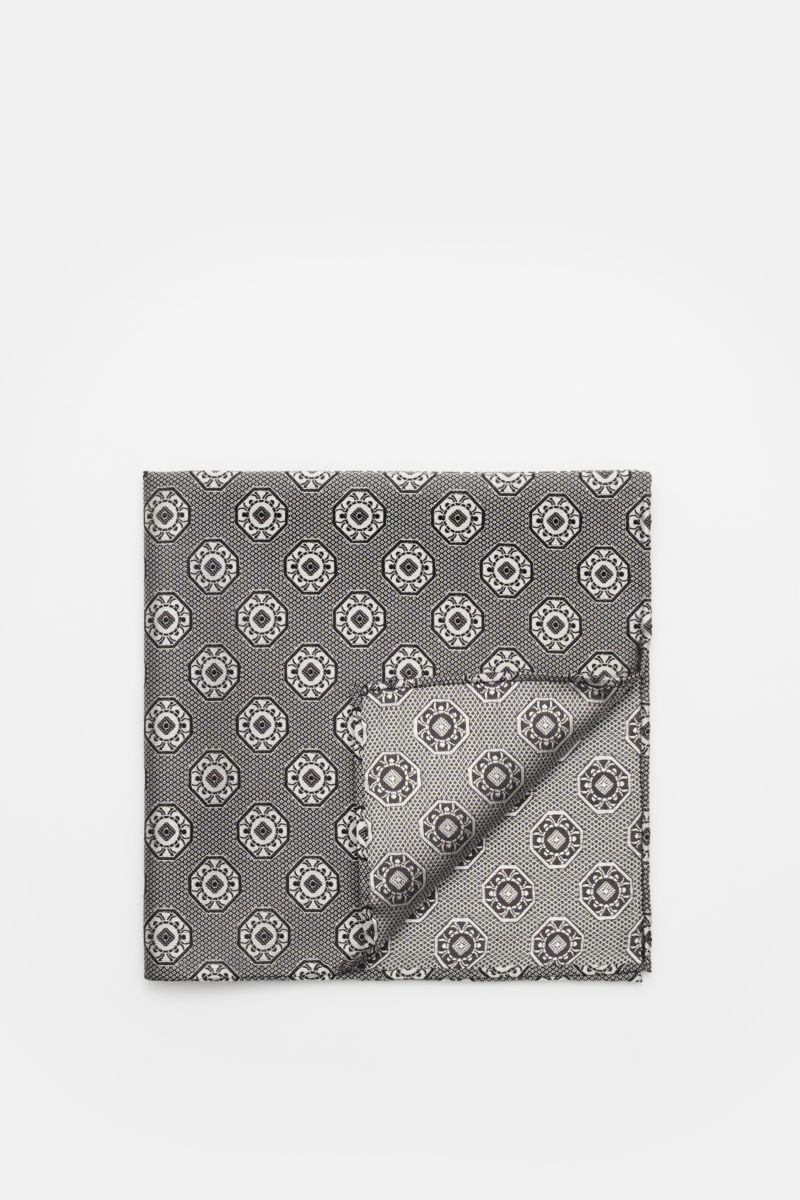 Top-down view of a folded Brunello Cucinelli Silk pocket square grey/black patterned with a fine medallion weave and rolled edges.

Elegant accent: This silk pocket square by BRUNELLO CUCINELLI has a fine medallion weave pattern that creates a subtle h