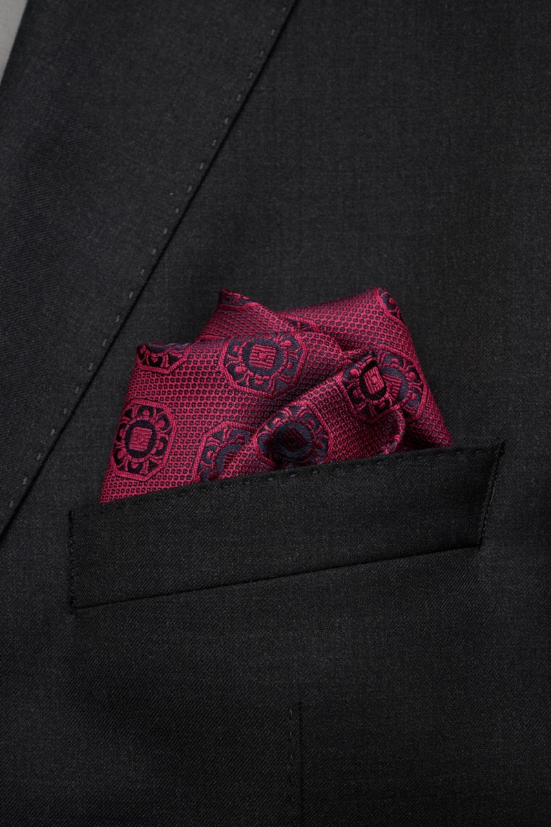 Close-up front view of a burgundy and dark navy patterned Brunello Cucinelli silk pocket square neatly folded in a black jacket pocket.

Description: Elegant accent: This silk pocket square by BRUNELLO CUCINELLI has a fine medallion weave pattern that 