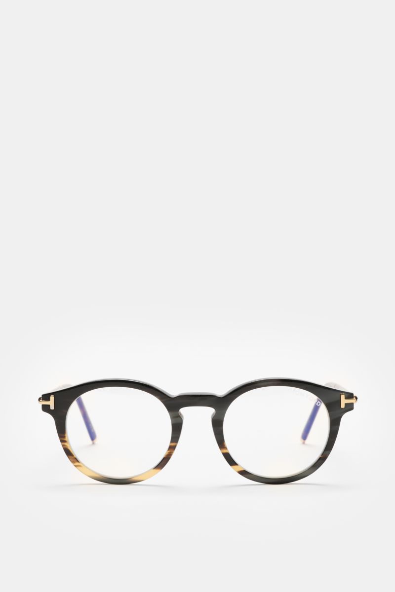 Front view of the Tom Ford Horn Brille 'Private Collection' schwarz/grau gemustert, a stylish round horn frame with blue light filter lenses and T-shaped gold details.  
Stilvoller Eyecatcher: Die exklusive Horn Brille aus der 'Private Collection' von 