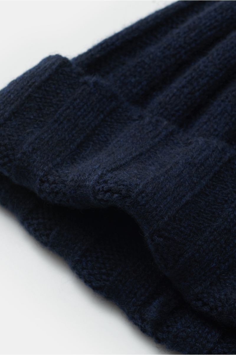 Nahaufnahme einer navyfarbenen FTC Cashmere Mütze navy aus feinem Fair-Trade-Cashmere mit weichem Griff, Rippstrick und schmalem Umschlag.