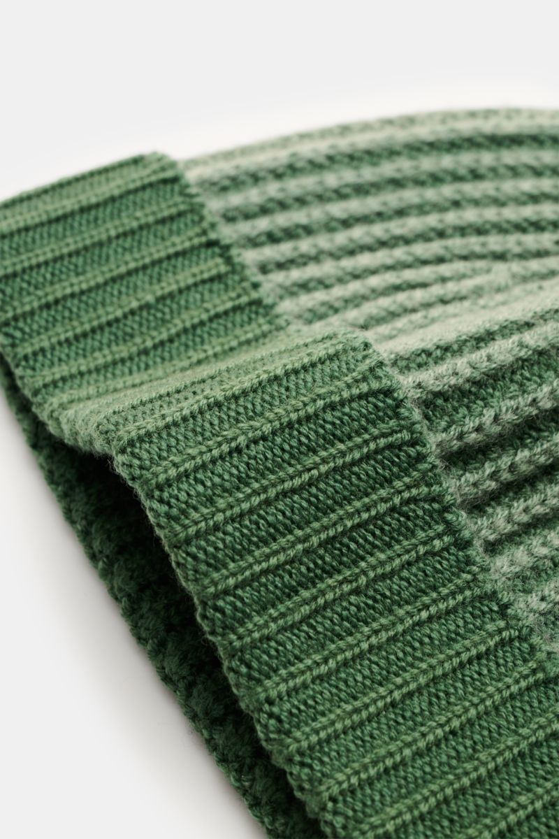 Close-up front-side view of 04651/ A trip in a bag Wool beanie 'Foggy Hat' green showcasing its rib knit pattern and small turn-up.