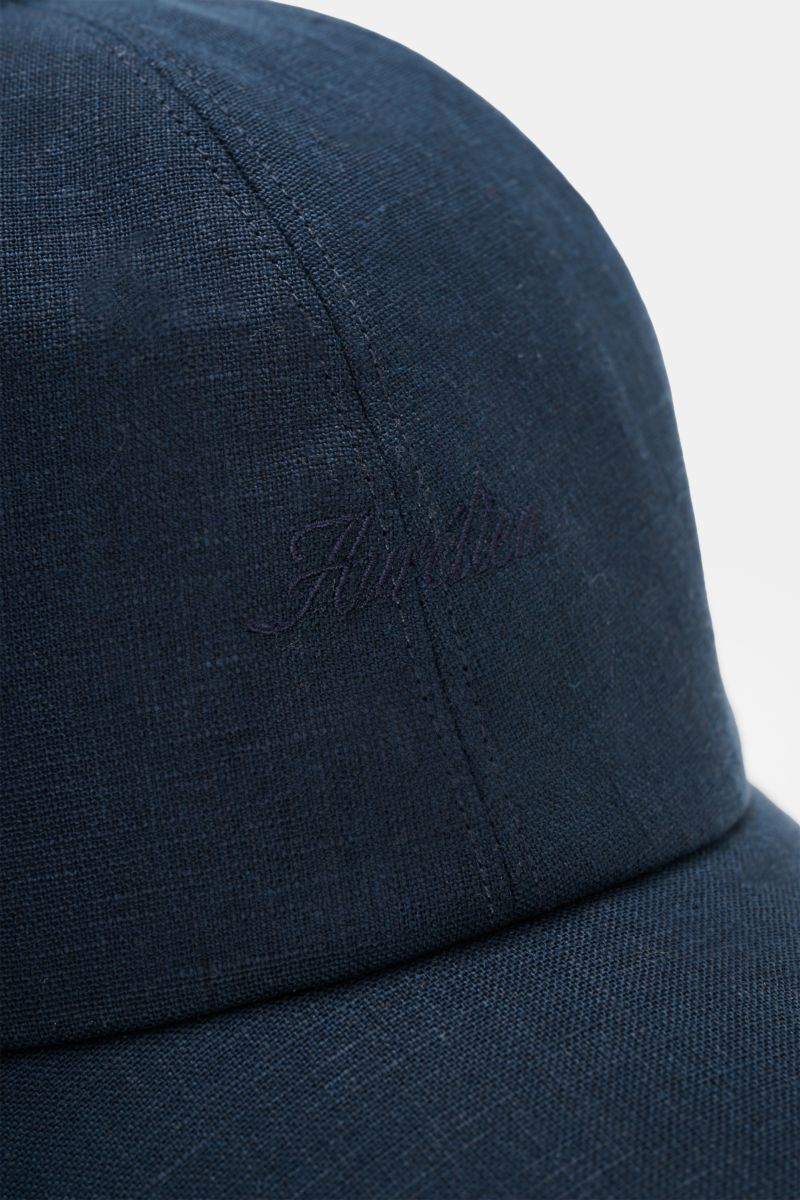 Aurélien Baseball-Cap navy aus reinem Leinen, Nahaufnahme von schräg vorne oben mit gebogenem Schirm, Six-Panel-Stil, tonales Logo-Stitching.