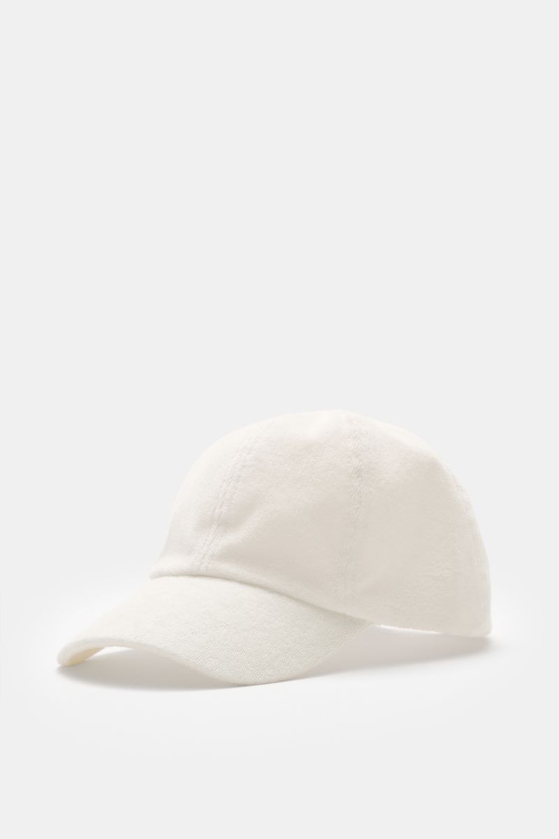 Front-side view of the 04651/ A trip in a bag Terry baseball cap 'Terry' cream in soft cotton terry, six-panel style with adjustable closure, offering a soft feel. Spring awakening: This stylish baseball cap from 04651/ A TRIP IN A BAG provides good prote