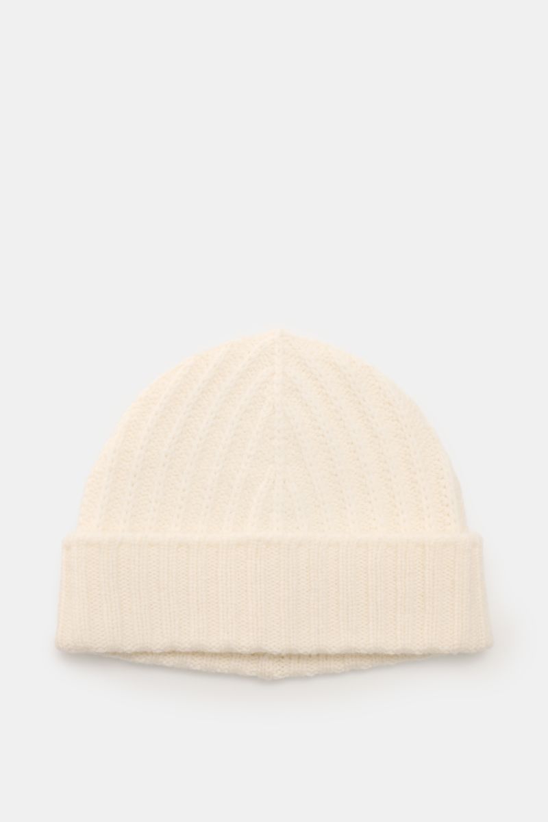 Top-down view of the 04651/ A trip in a bag Cashmere Mütze creme, a luxurious winter cream-colored cashmere beanie with soft feel, patent knit pattern, medium knit texture, and wide cuff.

Luxuriöses Winter-Accessoire: Die edle Cashmere-Mütz