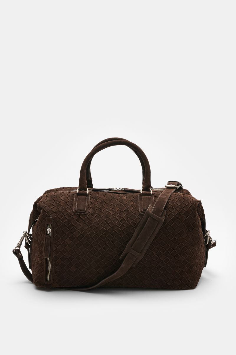 Front view of Officine Creative Weekender dunkelbraun in handwoven dark brown suede with matte silver hardware, sturdy handles, adjustable shoulder strap, and multiple zippered compartments.