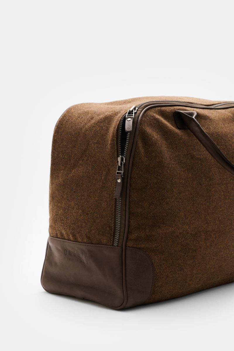 Side view of 04651/ A trip in a bag Weekender '356-Bag Tweed' brown mottled with fabric and leather, burnished hardware, and leather handles.