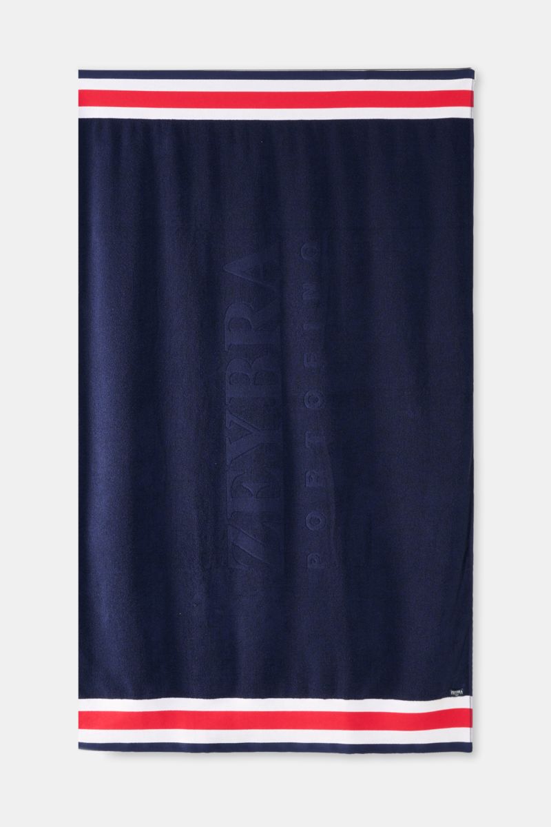 Zeybra Portofino 1962 Frottee-Strandtuch navy von oben fotografiert, mit Tricolore-Borte, weichem Baumwollfrottee und tonalem Logo, 100x230 cm.